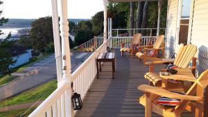 a porch with rocking chairs on a house at Hillside Landing B&B in Digby