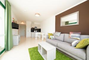 a living room filled with furniture and a couch at Apartamentos Galeon Playa in Costa Teguise