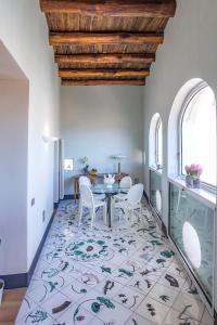 uma sala de jantar com uma mesa e cadeiras num tapete em Starhost - DIMORA COPETA em Salerno