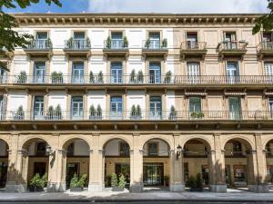 a large building with windows and balconies at Room Mate Collection Gorka, San Sebastián in San Sebastián
