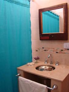 a bathroom with a sink and a mirror at Rinconcito en Tilcara in Tilcara