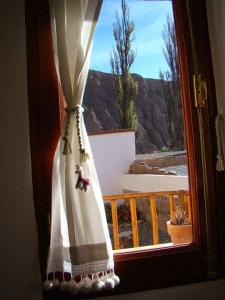 a window with a curtain with a teddy bear on it at Rinconcito en Tilcara in Tilcara