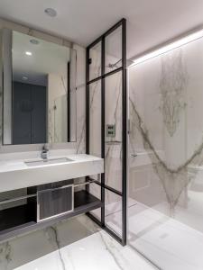 a bathroom with a sink and a shower at Room Mate Gorka in San Sebastián