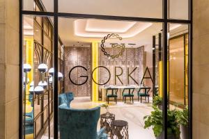 a restaurant with a table and chairs in front of a window at Room Mate Collection Gorka, San Sebastián in San Sebastián