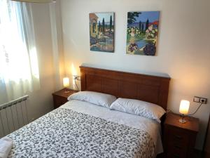 a bedroom with a bed and two pictures on the wall at Casa Rural La Guea de Teruel in Teruel