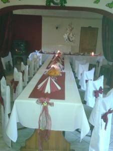 a long white table with a plate of food on it at Penzion Kamenný Dvůr in Vimperk