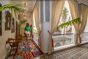 a person standing in front of a window with a parasol at Riad Jemaa El Fna & Spa in Marrakesh