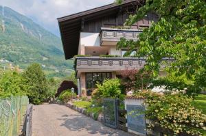 a house on a hill with a driveway at Haus Christl in Lana