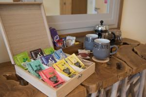 a wooden box with books and a cup on a table at The Lodge at Broadway in Broadway