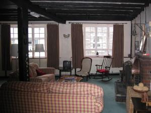a living room with couches and chairs and windows at The Horseshoe Guesthouse in Rhayader