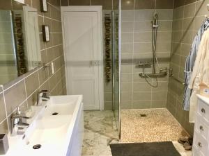 a bathroom with a white sink and a shower at Gîte chez Madeleine in Louhans +11 photos