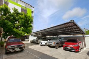 a parking lot with cars parked in front of a building at Je T'aime Hotel in Trang