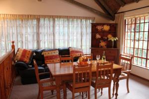 a living room with a table and a couch at Plotsklaps Self Catering Cottage in Tokai