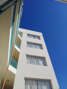 a white building with windows and a blue sky at Plaza in Buenos Aires
