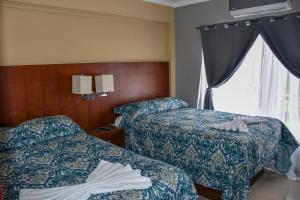 Postel nebo postele na pokoji v ubytování 12B Jaco Sol Quadplex