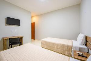TV a/nebo společenská místnost v ubytování Gabirá Hotel