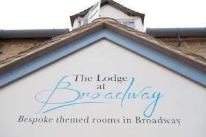 a sign that reads the lodge at brooklynopes themed rooms in broadway at The Lodge at Broadway in Broadway