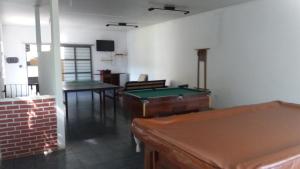 a room with a ping pong table and pool tables at Chácara do Seu Dito in Salto de Pirapora