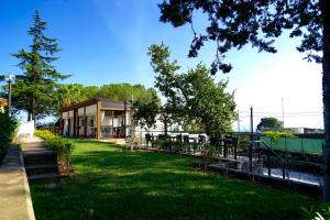 a building with a grassy yard in front of a building at Il Giardino di Agata in Mascalucia