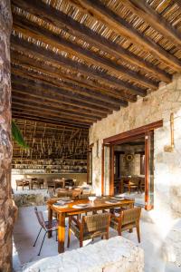 a dining room with wooden tables and chairs at Delek Tulum in Tulum