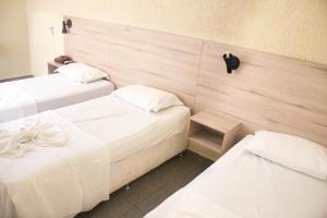 En eller flere senge i et værelse på Hotel Central Gold