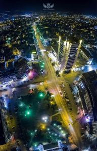 an aerial view of a city at night with lights at Apartment downtown in Pazardzhik