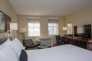 a hotel room with a bed and a desk and a television at Warwick Hotel Rittenhouse Square Philadelphia in Philadelphia