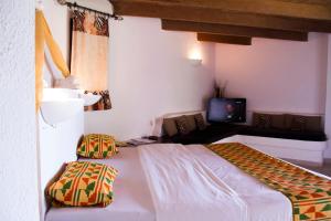 A bed or beds in a room at African Queen Lodge