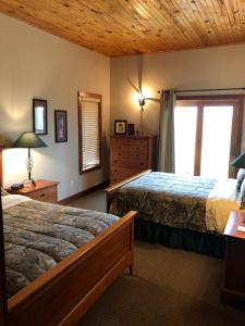 a bedroom with two beds and a window at ReWild Ranch LLC in Sargent +33 photos
