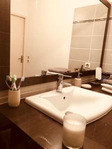 a bathroom with a sink and a mirror at Appartement 1 ROYAL VILLEROY in Sète +19 photos