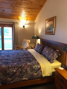 a bedroom with a bed and a chair at ReWild Ranch LLC in Sargent