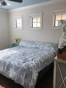 a bed in a bedroom with two windows at Resort Getaway in Destin