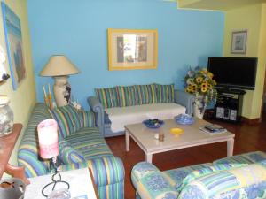 a living room with two couches and a tv at Casa na praia e golfe in Vale do Lobo
