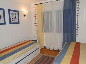 A bed or beds in a room at Luxuoso apartamento na praia