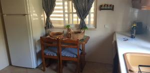 a kitchen with a table and two chairs with baskets on it at Arrábida com Requinte in Palmela