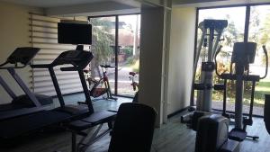 a gym with two treadying machines and a large window at Grand Hotel Montabo in Cayenne