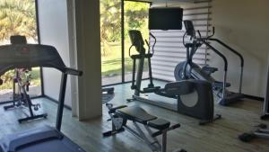 a gym with several exercise bikes and a television at Grand Hotel Montabo in Cayenne