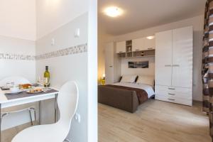 a bedroom and a bedroom with a bed and a kitchen at Guest House Krk Town Centre in Krk