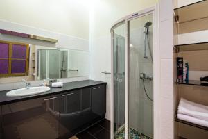a bathroom with a sink and a shower at Old Riga Jekaba street Apartment in Riga