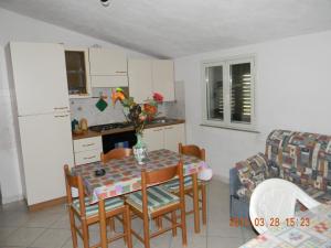 uma cozinha e sala de jantar com mesa e cadeiras em Casa Concetta em Noto Marina