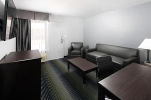 a living room with a couch and a table at Red Lion Inn & Suites Tucson Downtown in Tucson