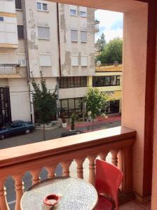 a balcony with a table and chairs and a window at Apartman Andrea, BN centar in Bijeljina