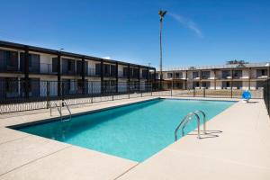 a swimming pool in front of a building at Red Lion Inn & Suites Tucson Downtown in Tucson