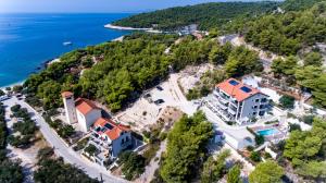 an aerial view of a house on a hill next to the ocean at Luxurious Apartments Maslina with Beach in Milna