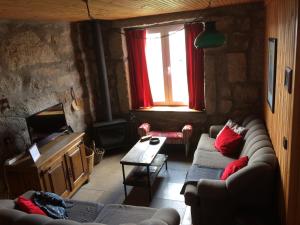 a living room with a couch and a table at Casa da Moita in Moita