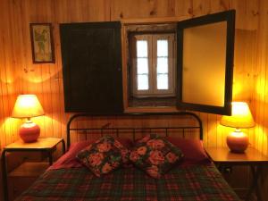a bedroom with a bed with two lamps and a mirror at Casa da Moita in Moita