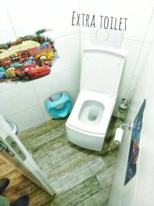 a bathroom with a white toilet in a room at River Cave Apartment Slovenia in Visoko