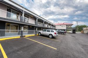 a car parked in a parking lot in front of a building at Olympia Lodge in Calgary