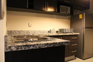 a kitchen with a stove and a counter top at Departamento zona dorada in Mazatlán