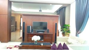 a living room with a tv and a couch at Tamu Apartment Kuala Lumpur by Q Luxe in Kuala Lumpur